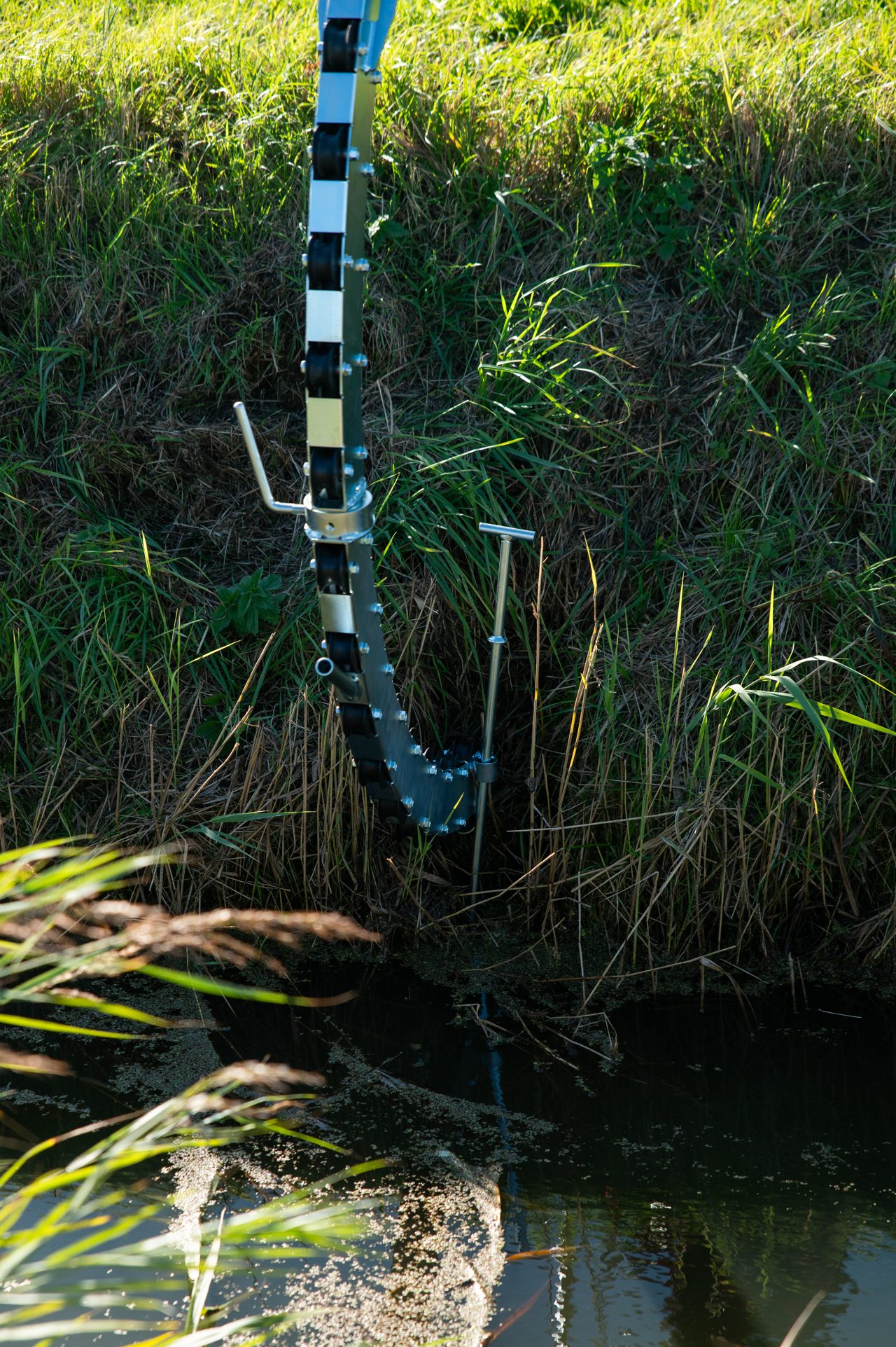 Homburg drain cleaner hose clearing an agricultural drainage line in the field